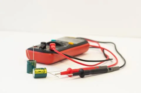 Multimeter with test probes and capacitors Foto stock