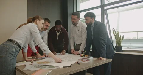 Multinational Business Team Collaborates on Project, Reviewing Blueprints in Stock Footage 314532974
