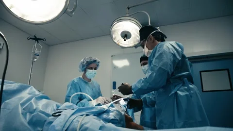 Multinational collaborative team of surgeons performing Stock Footage 270141780