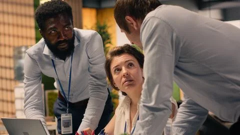 Multinational company work team collaborating on performance metrics Stock Photos