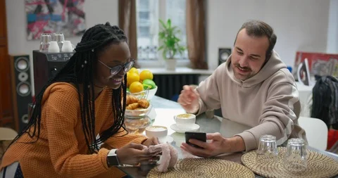 Multinational couple of freelancers talking in kitchen in studio apartment Stock Footage 99319001