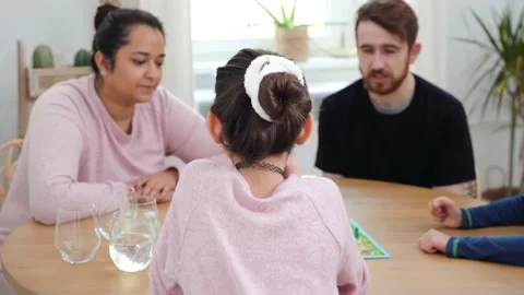 Multinational family playing with board game indoors Stock Footage 169819939