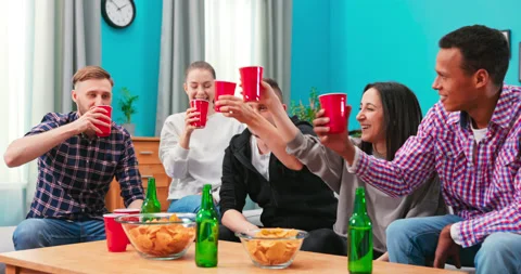 Multinational Friends having small home party, meeting, sitting on couch 動画素材 152373814