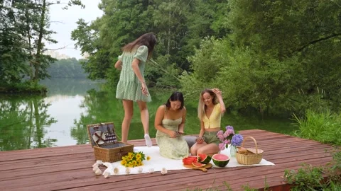Multinational girls preparing place for Lunch Picnic holiday weekend conception Stock Footage 158886014