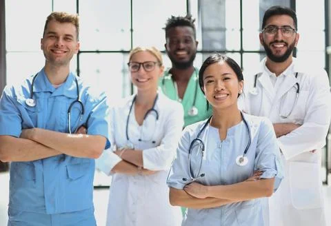 Multinational group of doctors and interns standing together. Stock Photos
