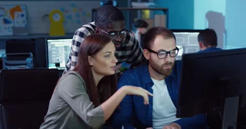 Multinational group of three people working on joint task while sitting in Stock Footage 140289700