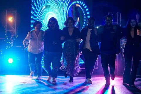 Multinational night party funny people dancing at outdoor dance floor with .. Stock Photos
