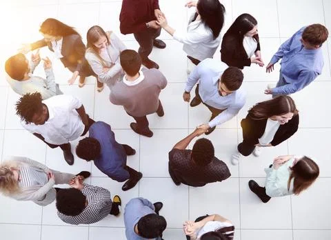 Multinational office workers and foreign employees stand and talk in the office Stock Photos