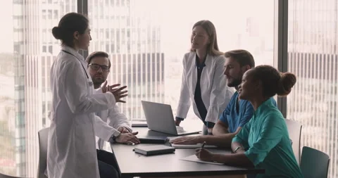 Multinational physicians having professional medical discussion gathered in Stock Footage 253125981