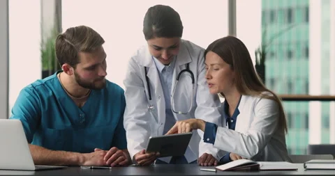 Multinational staff of clinic using digital tablet at workplace Stock Footage 253129451