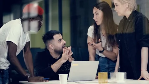 Multinational team of creative young people solve business problems in a meeting Stock Footage 140991997