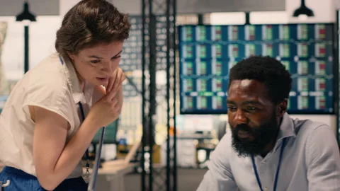 Multinational work team analyzing business intelligence reports and metrics Stock Footage 329329466