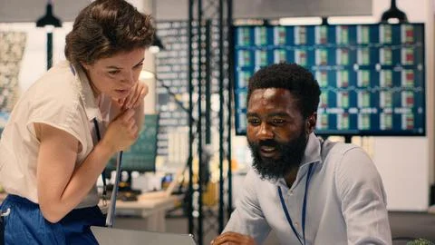 Multinational work team analyzing business intelligence reports and metrics Stock Photos