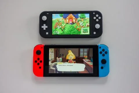 A multiplayer Nintendo Switch and single player Nintendo Switch Lite gaming c Stock Photos
