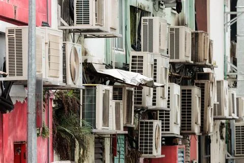 Multiple air-conditioning units stacked in a street of Singapore Stock Photos
