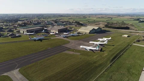 Multiple aircraft grounded at small airport outside hangars, drone aerial 4K Stock Footage 101224797