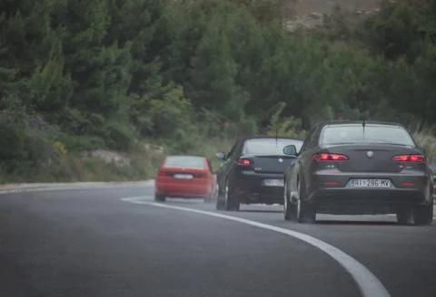 Multiple Alfa Romeos driving in a column. Enthusiasts owners meeting and driv Stock Photos