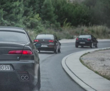 Multiple Alfa Romeos driving in a column. Enthusiasts owners meeting and driv Stock Photos