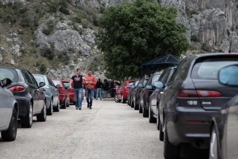 Multiple Alfa Romeos lined up at a car park in a row. People walking among th Foto stock