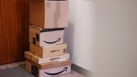 Multiple Amazon Prime cardboard parcels near apartment door 스톡 동영상 100823430
