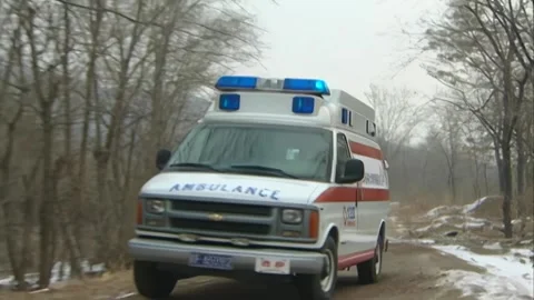 Multiple ambulances driving on a small road Stock Footage 253771566