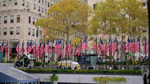 Multiple American flags on the flagstaffs in the street of the city. Stock Footage 321183282