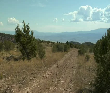 Multiple ATVs pass camera with mountains in distance Stock Footage 21634486
