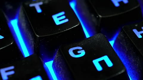 Multiple backlit keyboard keys dim close-up Video stock 144024283