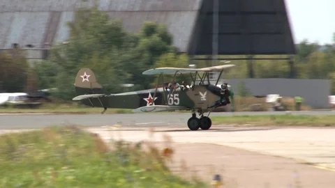 Multiple biplane multiplying U-2 or Po-2 (Mule) - taxis on runway after landing. Stock Footage 116318472