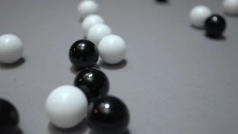 Multiple black and white balls rolling toward camera Stock Footage 147463230