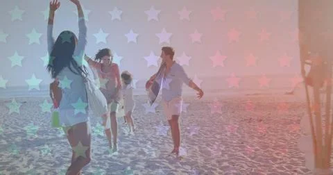 Multiple blinking stars against group of friends walking at the beach Stock Photos