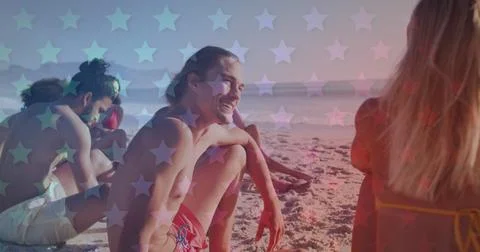 Multiple blinking stars against group of friends sitting on the beach Stock Photos