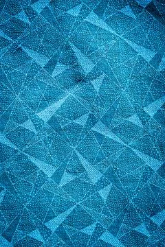 Multiple blue geometric triangle shapes on vintage fabric Foto stock