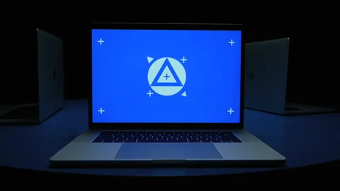 Multiple blue screen laptops circling from laptop to laptop Stock Footage 220533195