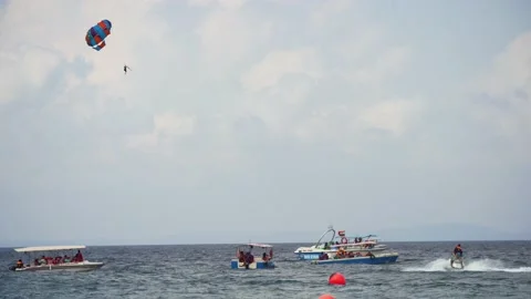 Multiple boats in distance doing para gliding sailing while adventure sports Stock Footage 172210324