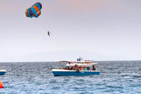 Multiple boats in distance doing para gliding sailing while adventure sports  写真素材