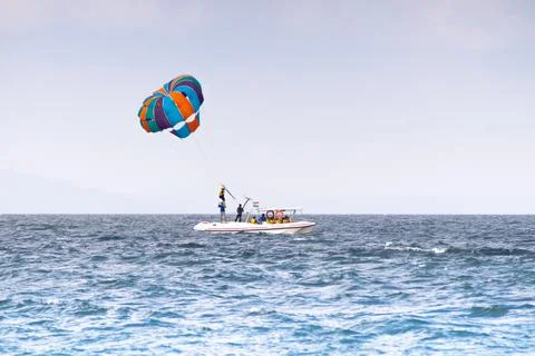 Multiple boats in distance doing para gliding sailing while adventure sports  写真素材