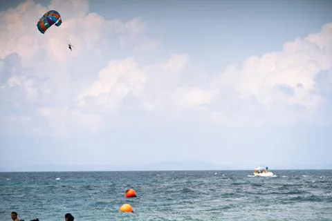 Multiple boats in distance doing para gliding sailing while adventure sports  Stock Photos