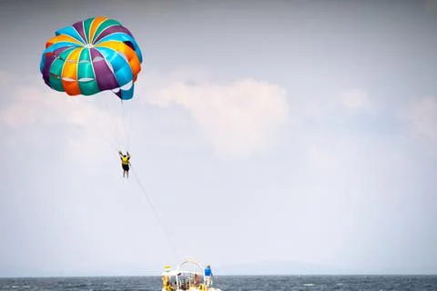 Multiple boats in distance doing para gliding sailing while adventure sports  Stock Photos