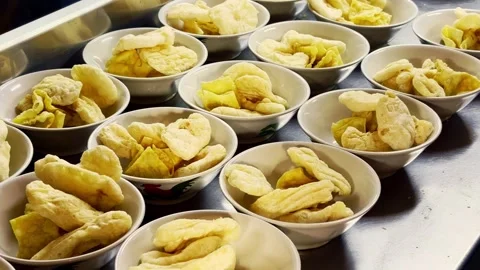 Multiple bowls filled with crispy golden snacks await customers at a prepar.. Stock Footage 340060102