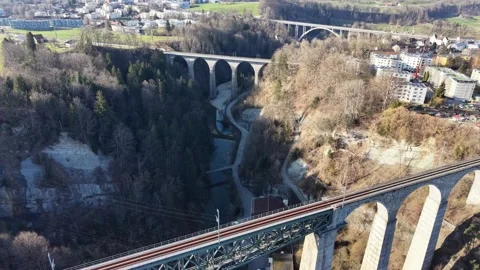 Multiple Bridges Over Gorge With Train And Road Traffic Aerial View 스톡 동영상 330082859
