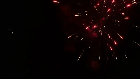 Multiple bright colourful fireworks explode and sparkle against night sky Stock Footage 224934909