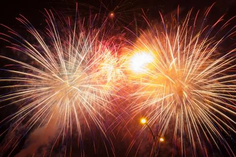 Multiple bright yellow red fireworks Stock Photos