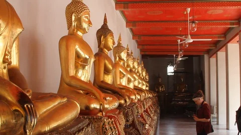 Multiple Buddhas at Buddist temple of Wat Suthat Thepwararam Video stock 129808060