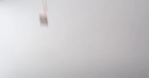 Multiple bulldog clips fall onto a white table top Stock Footage 117349486