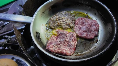 Multiple Burger Patties Frying in Pan at Thai Night Market Street Food Stall Stock Footage 330571339