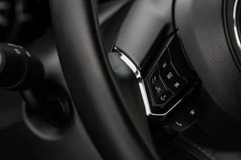 Multiple buttons on the steering wheel to accept or reject calls from the pho Stock Photos