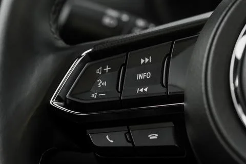 Multiple buttons on the steering wheel to accept or reject calls from the pho Stock Photos