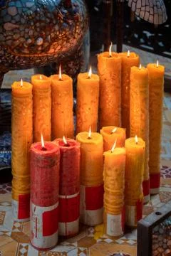 Multiple candles with flames inside temple in Ho Chi Minh city Stock Photos