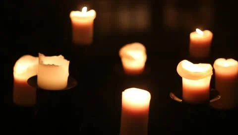 Multiple candles on stand in low lighting rack focus Stock-Footage 11141492